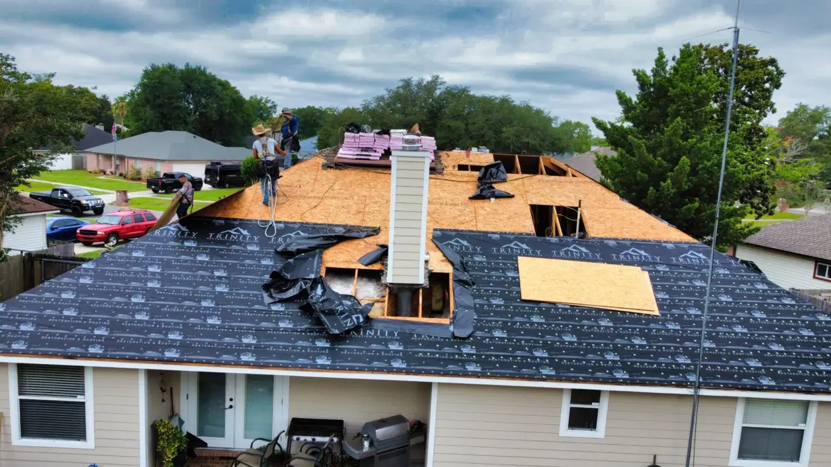 Roof replacement in progress with fresh decking around a chimney