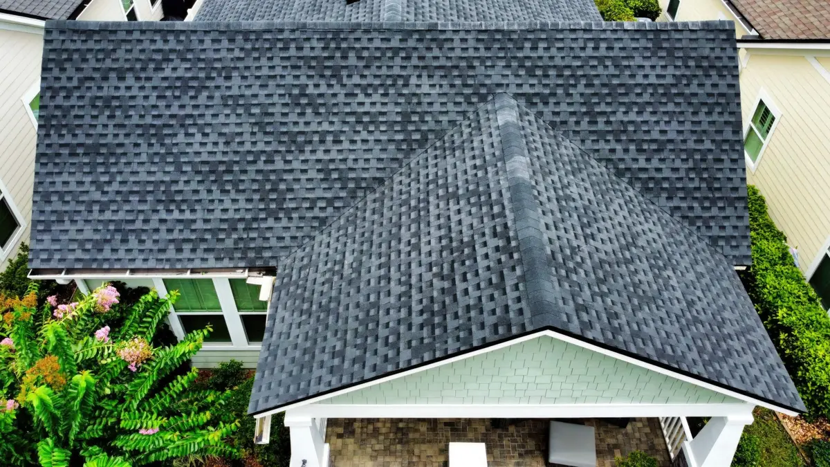New dark shingle roof over a covered back porch