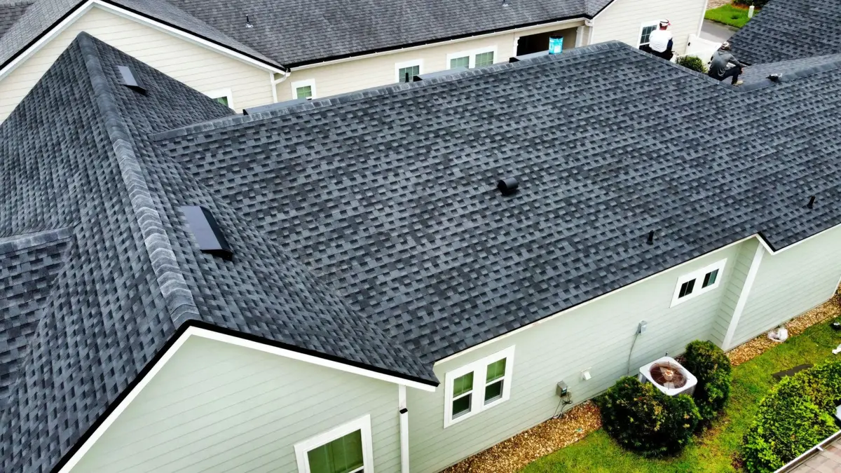 Close view of a completed shingle roof and gutters