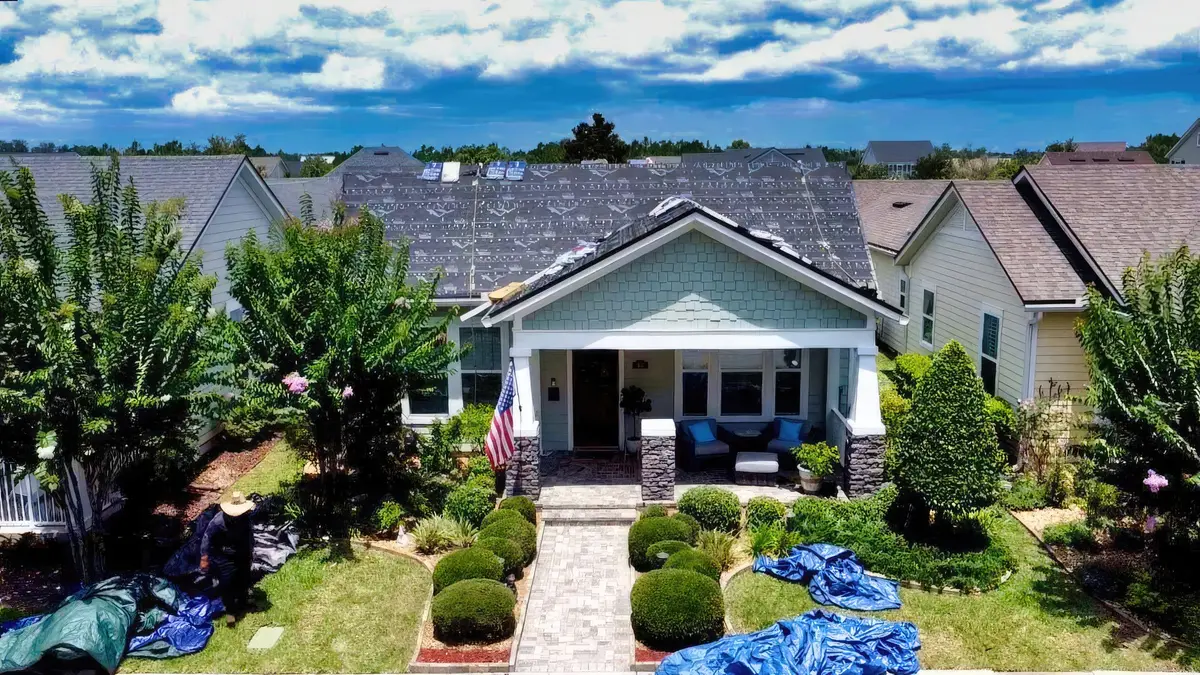 Finished roof on a single-story Florida home with landscaped front yard